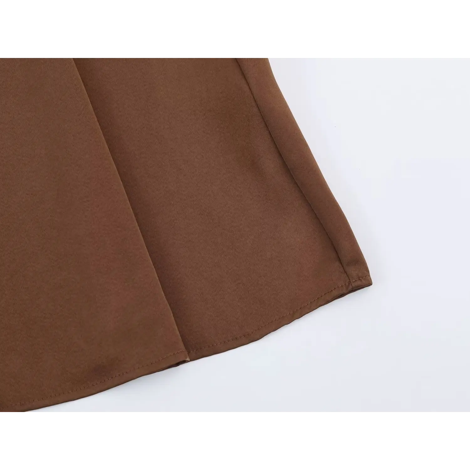Close‑up of finished hem stitching on brown satin maxi dress