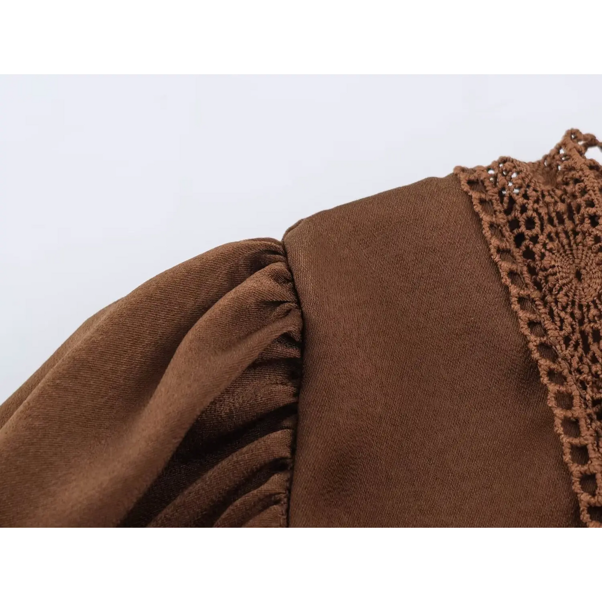 Close‑up of gathered puff shoulder fabric texture brown long sleeve maxi dress