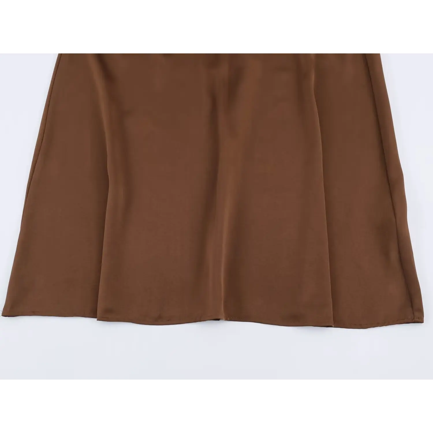 Full view of skirt hem and fabric flow for brown satin maxi dress