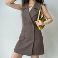 Model wearing brown sleeveless blazer double breasted mini dress with butterfly necklace and yellow bag