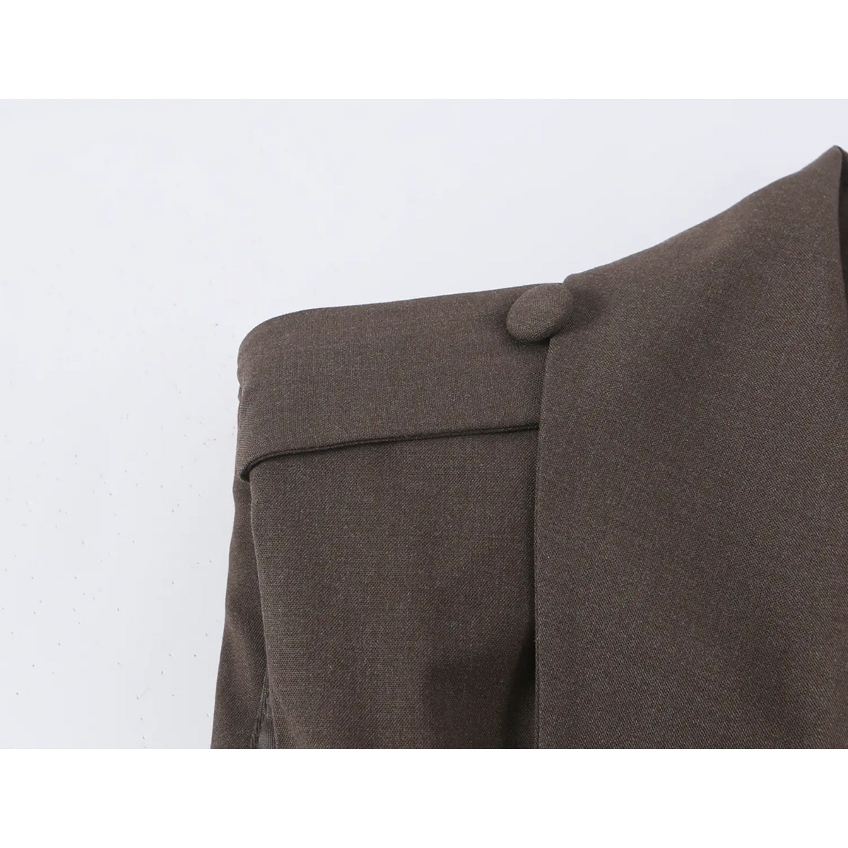 Close-up of structured shoulder and button