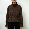 Model wearing brown suede cropped peplum jacket with black trousers