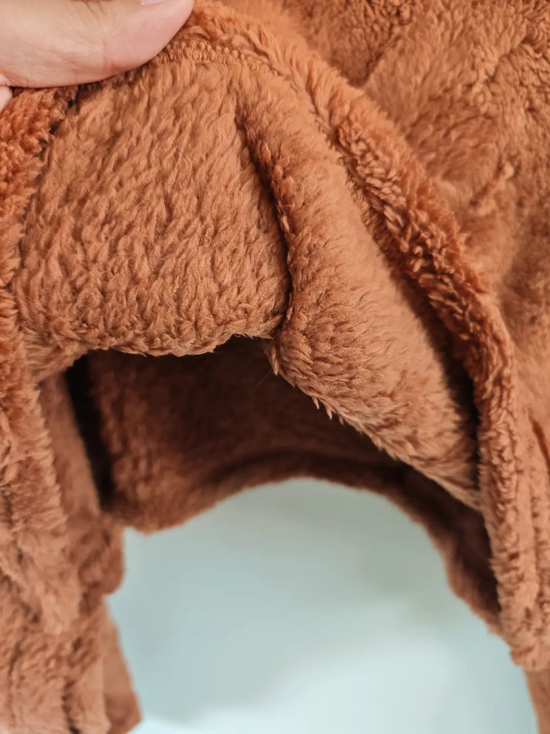 Close-up of teddy fleece fabric fold and edge