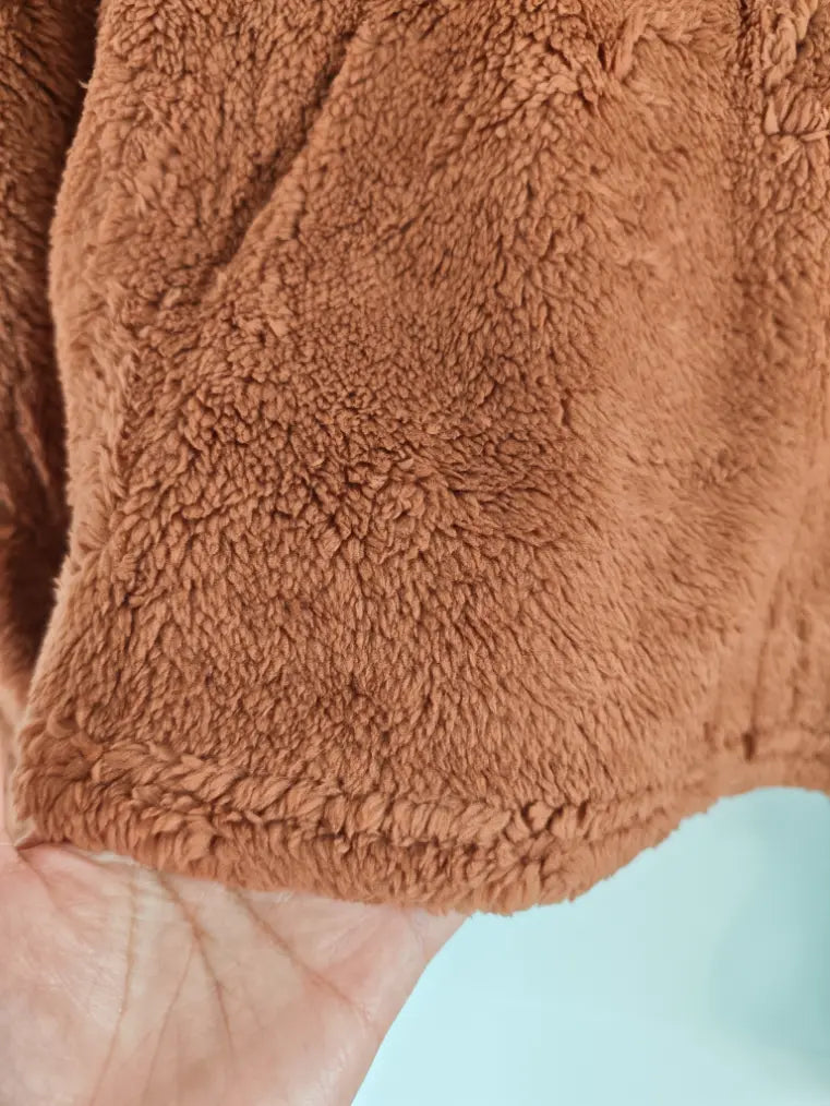 Close-up of cropped hem and teddy fleece texture