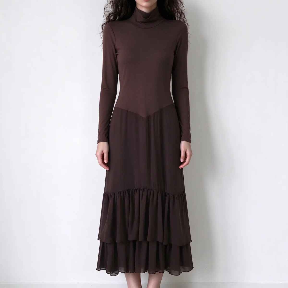 Model wearing brown turtleneck ruffle tiered midi dress, front view