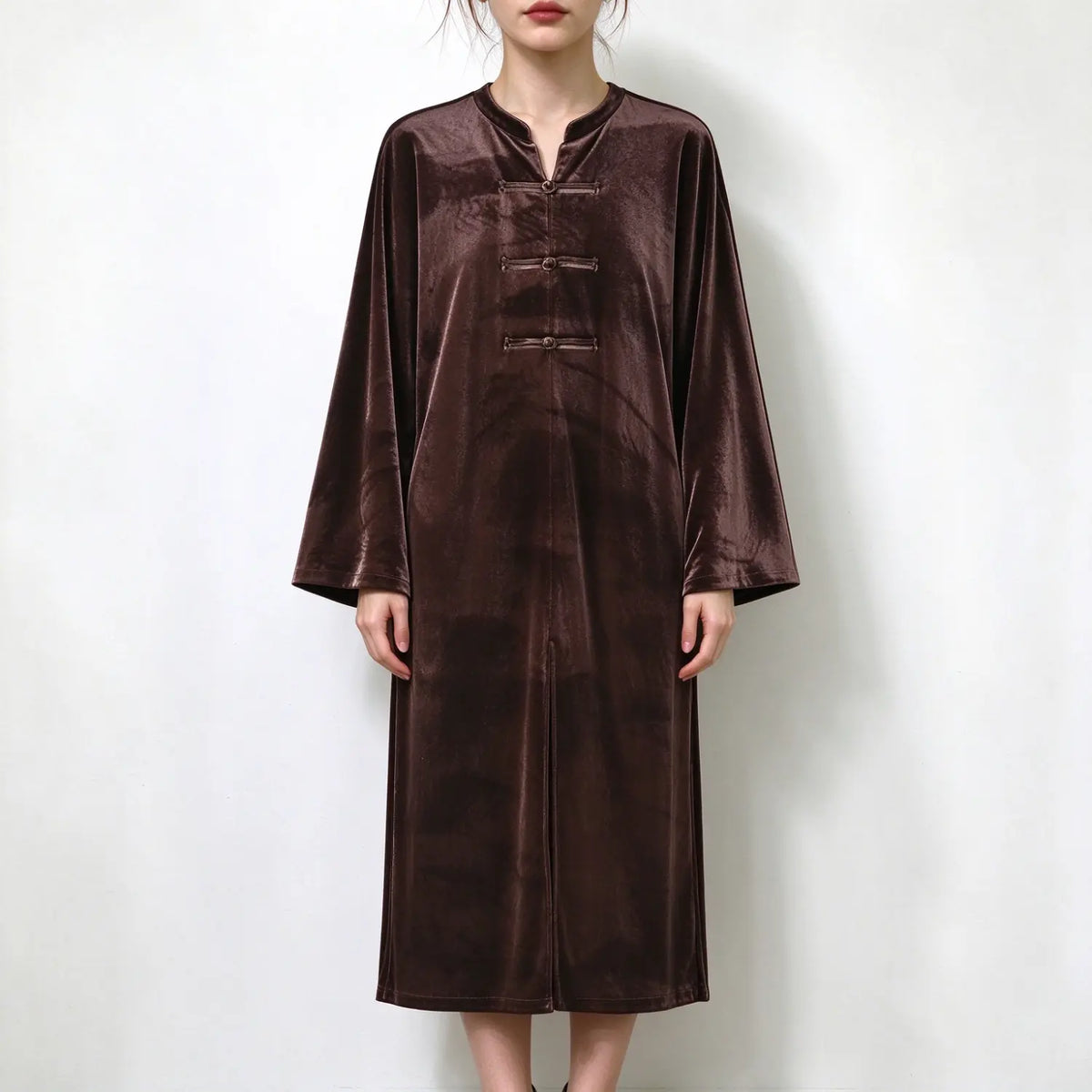 Model wearing brown velvet frog button midi dress, front view