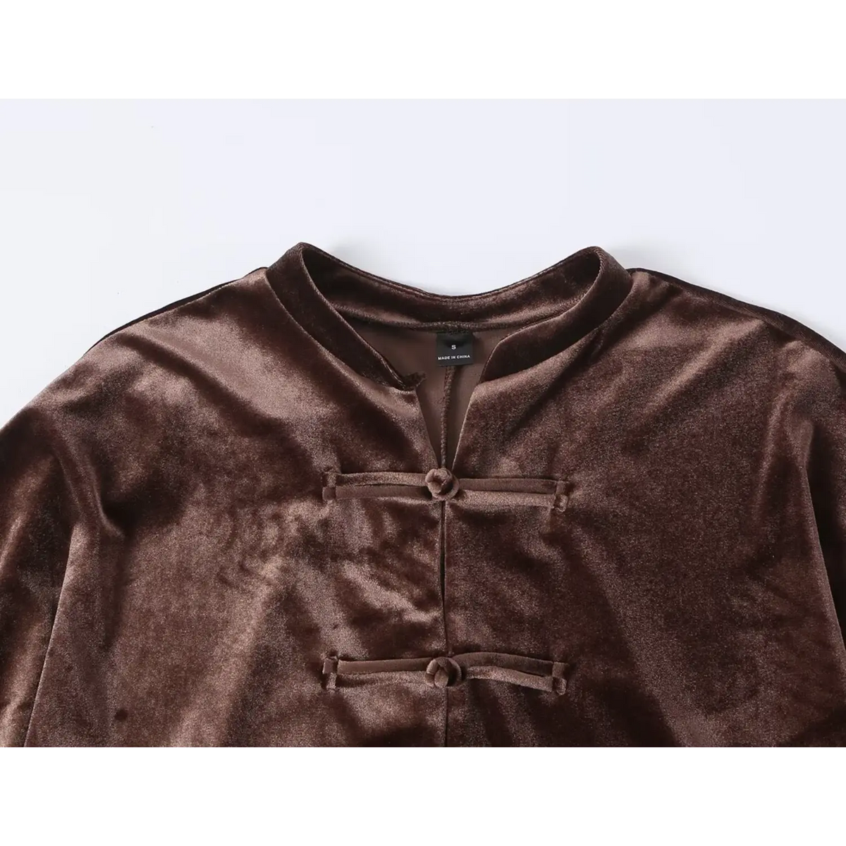 Close-up of neckline and frog buttons