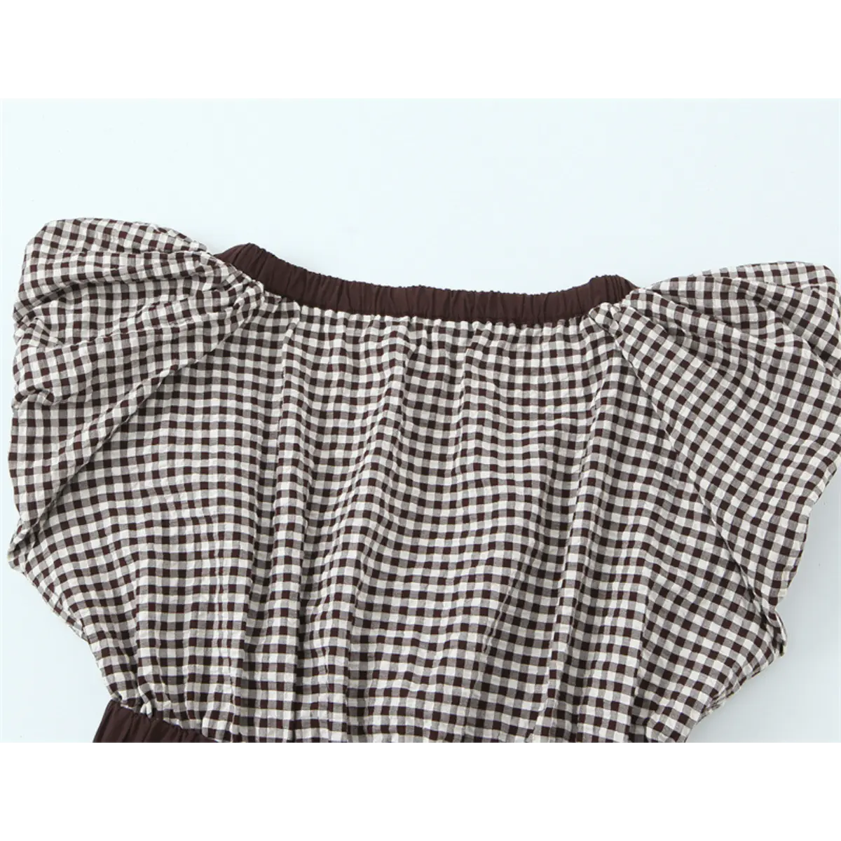 Back view of the gingham top, showing the elasticated neckline and puff sleeves