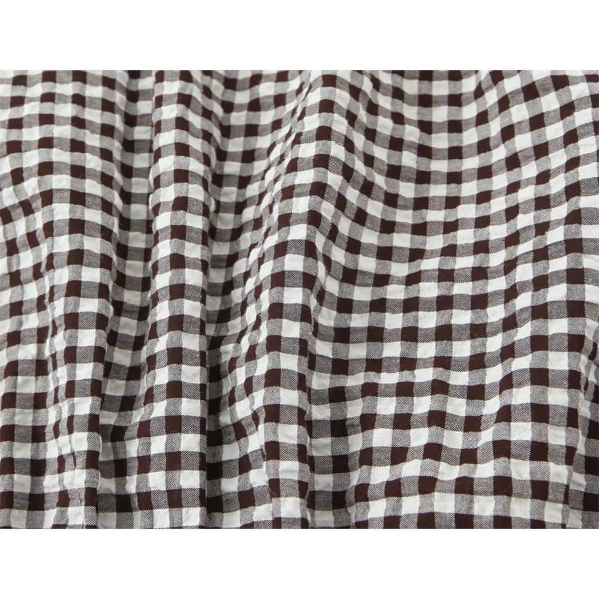 Close-up of the brown and white gingham fabric, showing the checkered pattern and textured weave