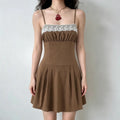  Model wearing a brown camisole mini dress with a white lace-trimmed bust, gathered fabric, and a flared skirt.