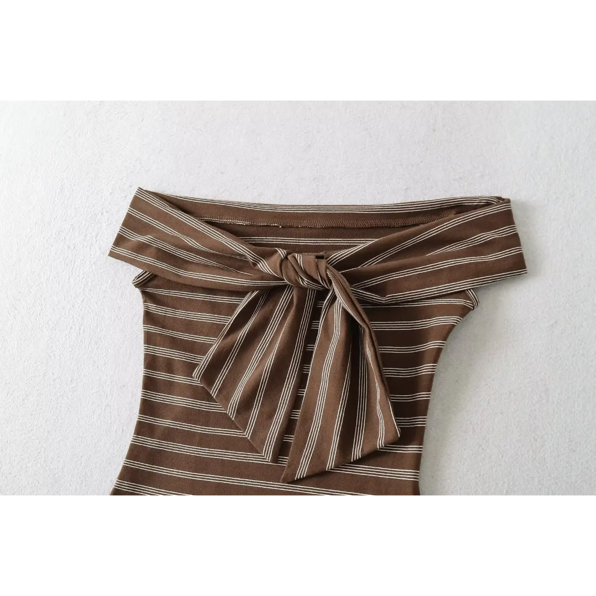 Full front shot of the brown and white striped off-shoulder top, featuring the front tie detail and form-fitting silhouette.