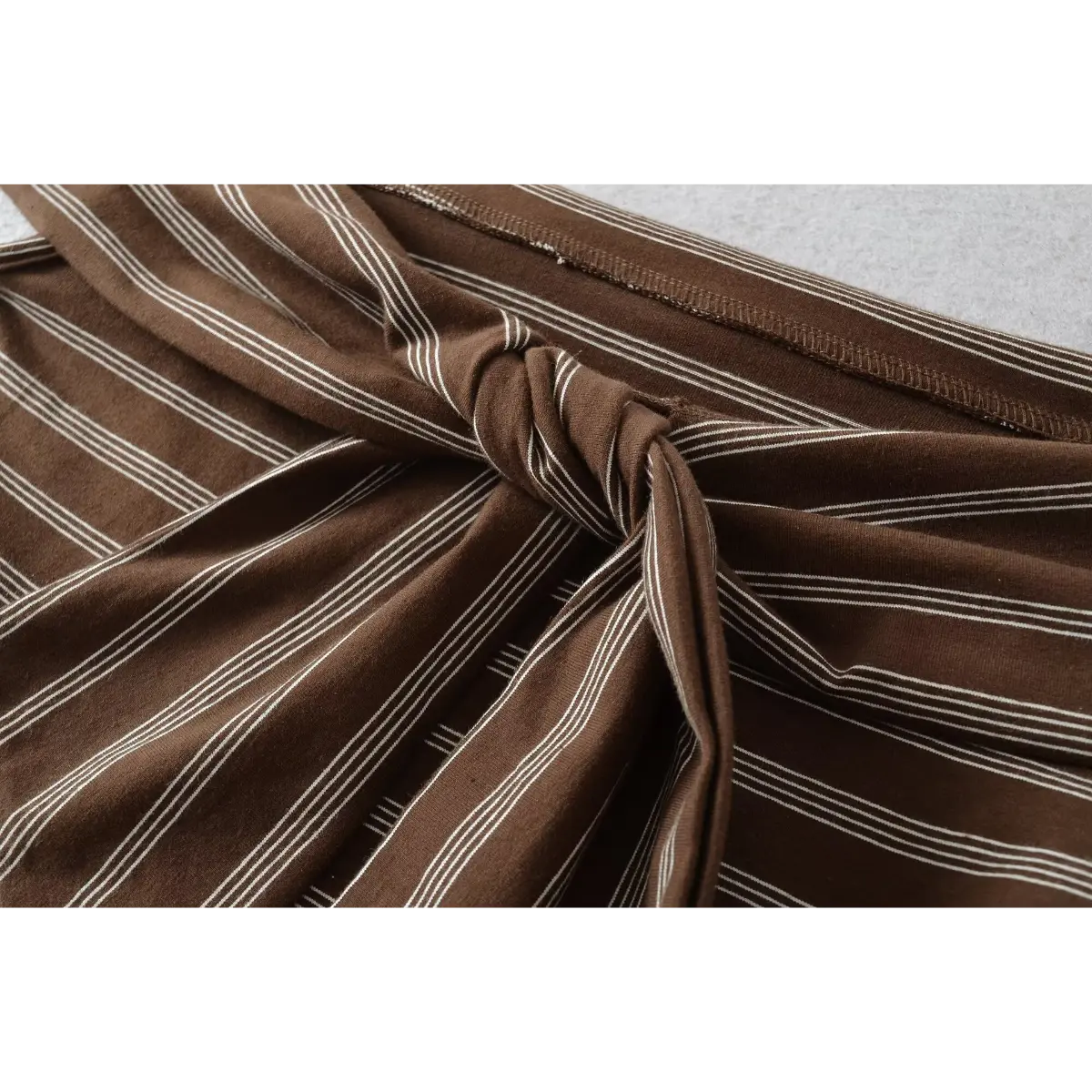 Close-up of the twisted knot detail at the front, showcasing the fabric's stretch and stripe pattern.