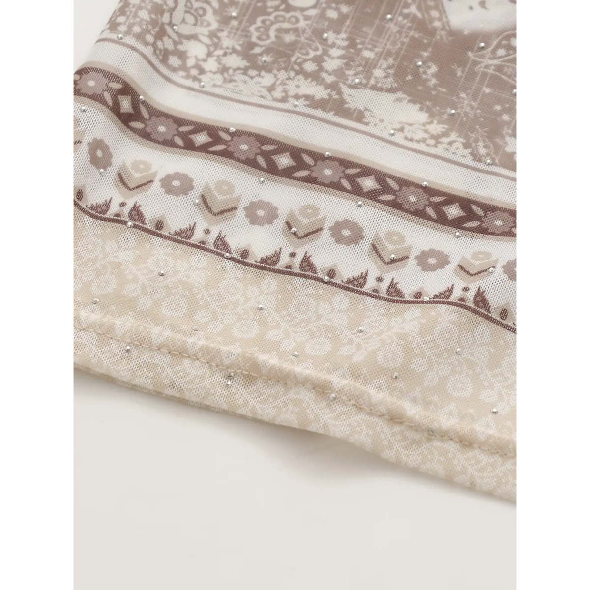 Close‑up of decorative border print at dress hem