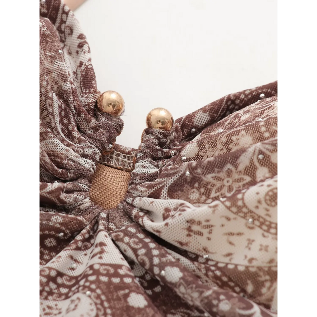 Close‑up of front bust knot with small bead ornament detail