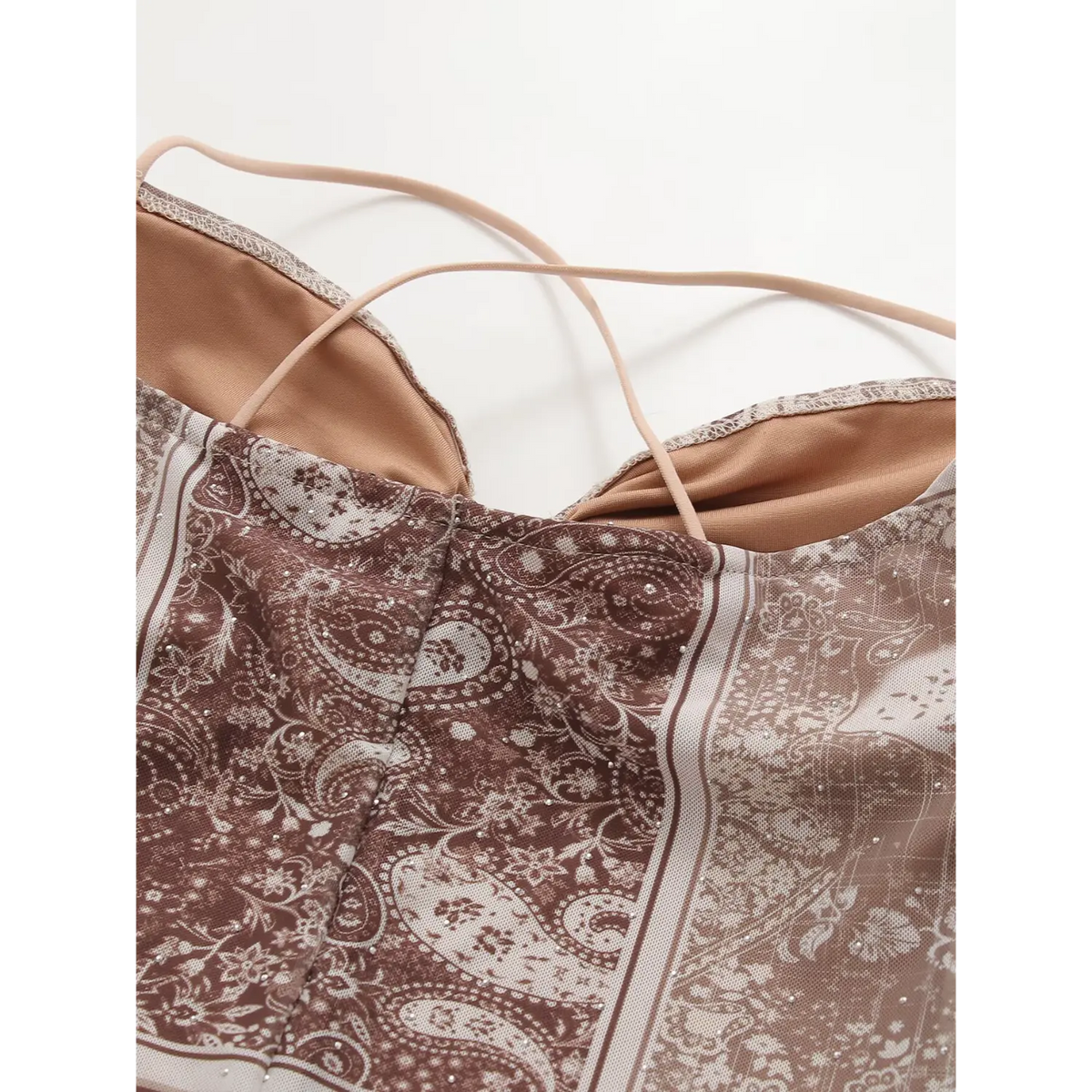 Close‑up of inner lining and thin crisscross shoulder straps
