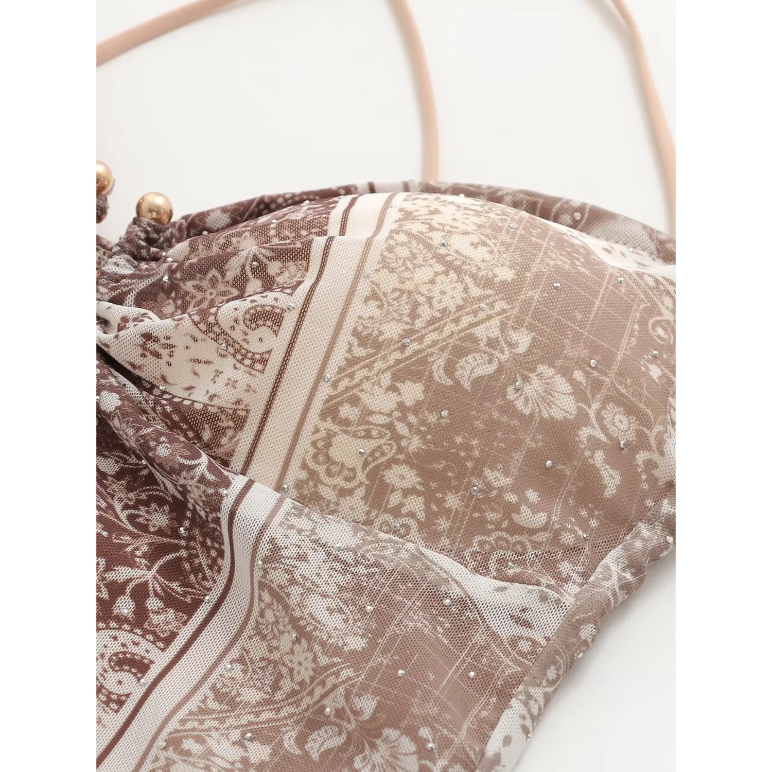Partial close‑up of side zipper on brown paisley cami maxi dress