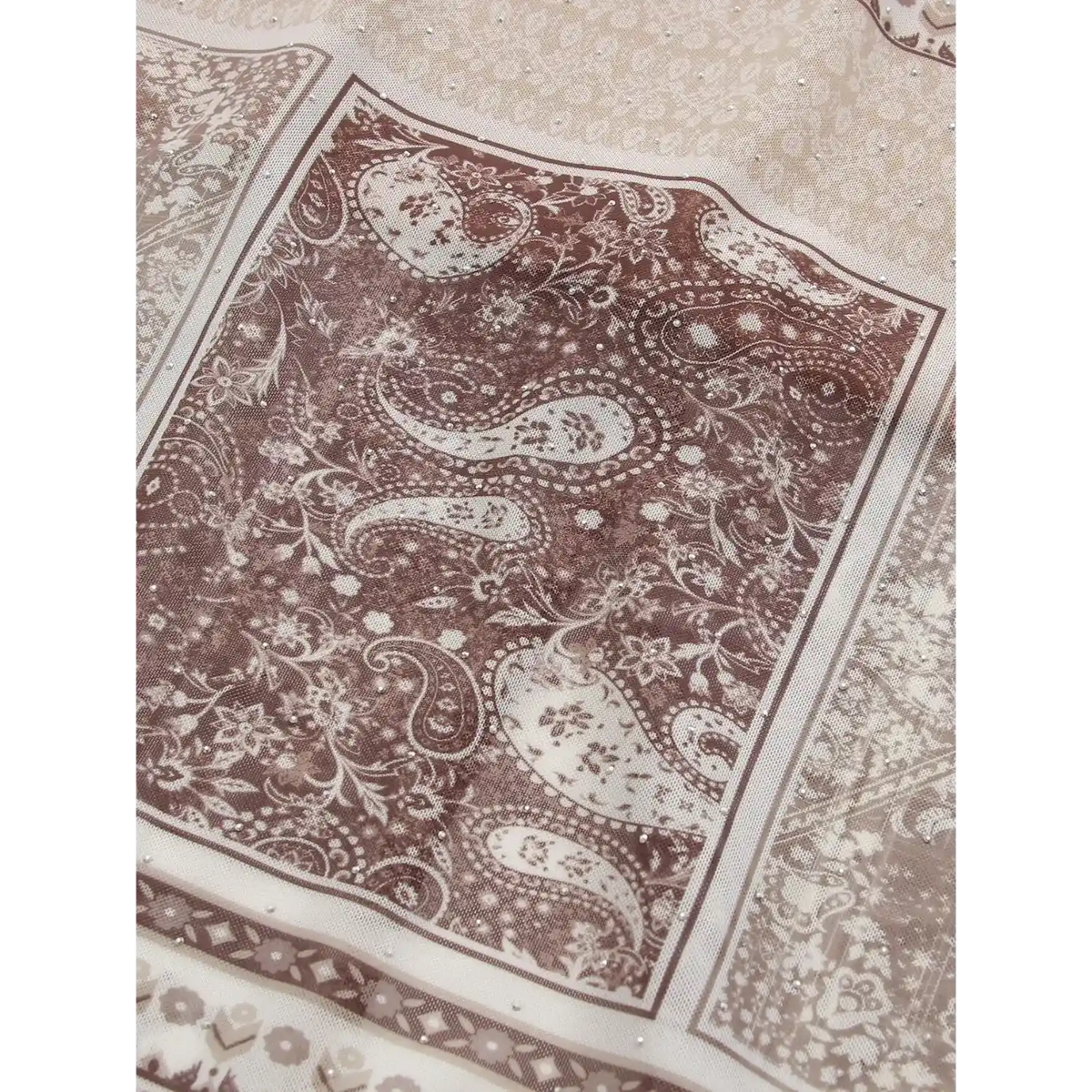 Macro close‑up of vintage brown paisley print fabric texture