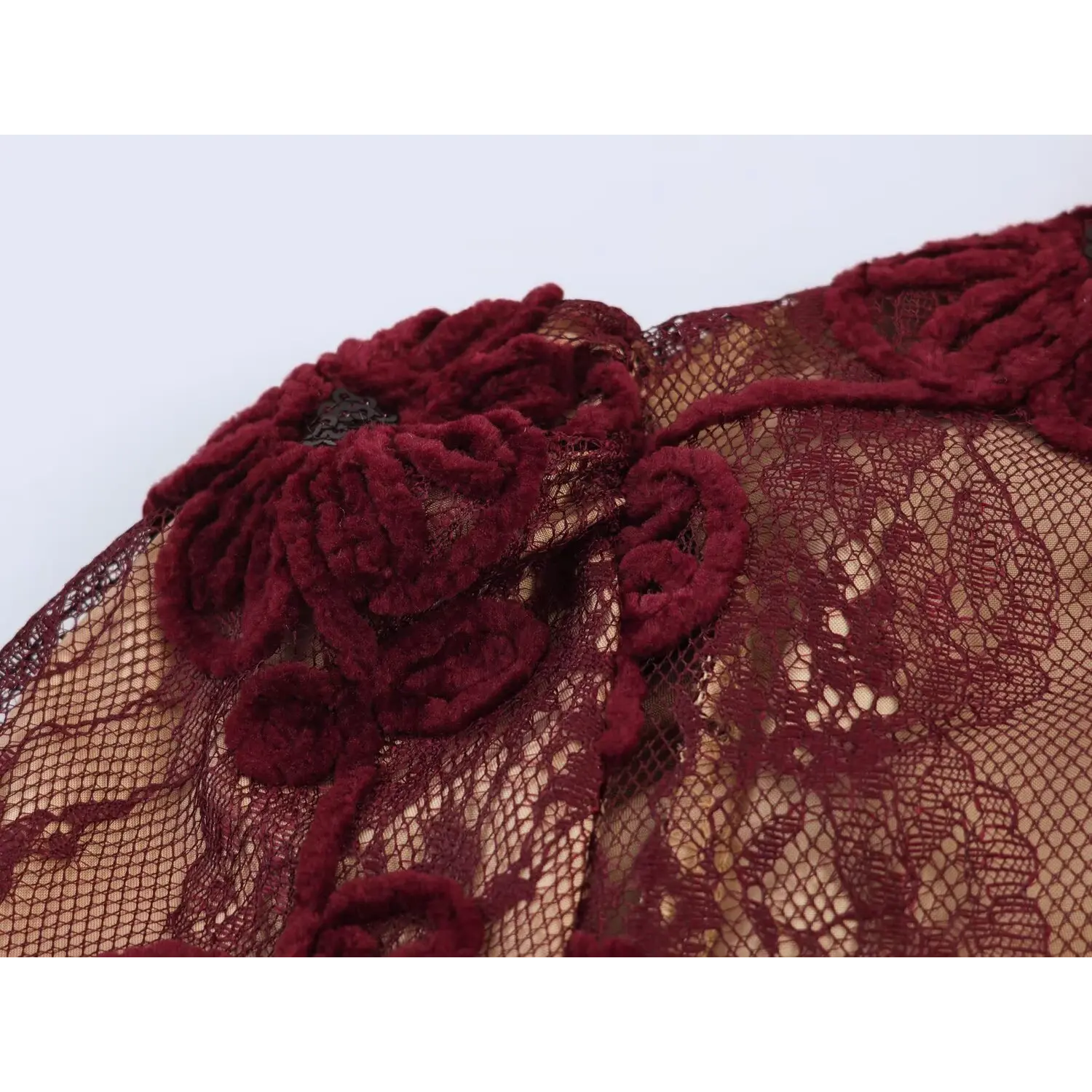 Close‑up fabric shot burgundy maxi dress textured 3d floral applique on sheer lace mesh