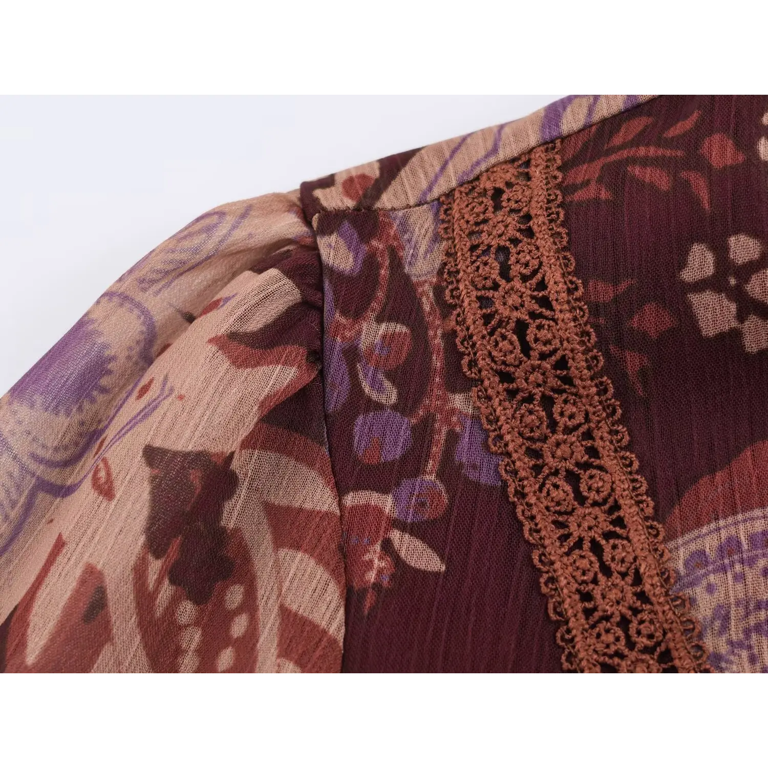 Shoulder close-up showing handmade crochet lace trim and balloon sleeve stitching detail
