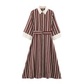 Front view burgundy cream vertical stripe shirt maxi dress with D‑ring belt, contrast collar and cuffs
