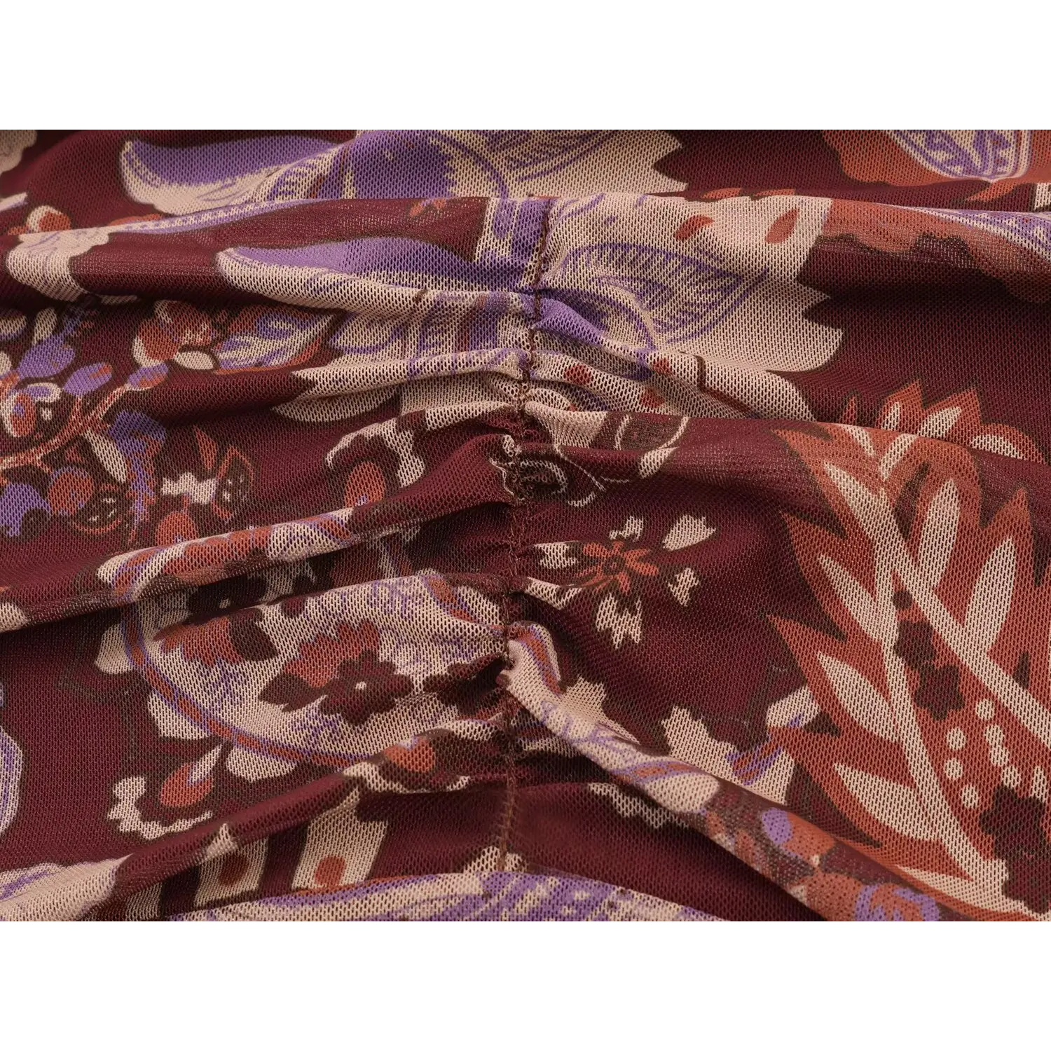 Close‑up of waist ruched stitching construction on burgundy paisley mesh maxi dress