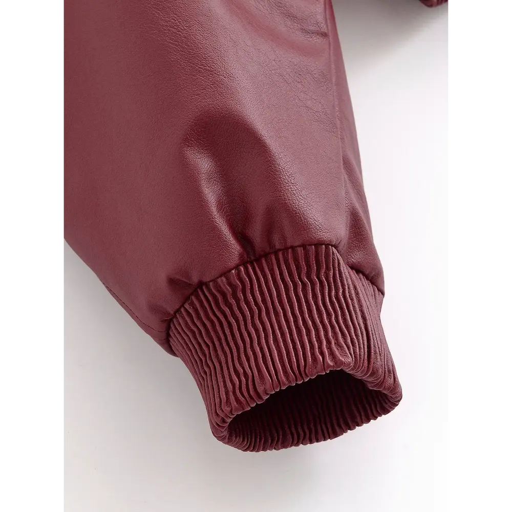 Close-up of ribbed knit cuff and leather sleeve