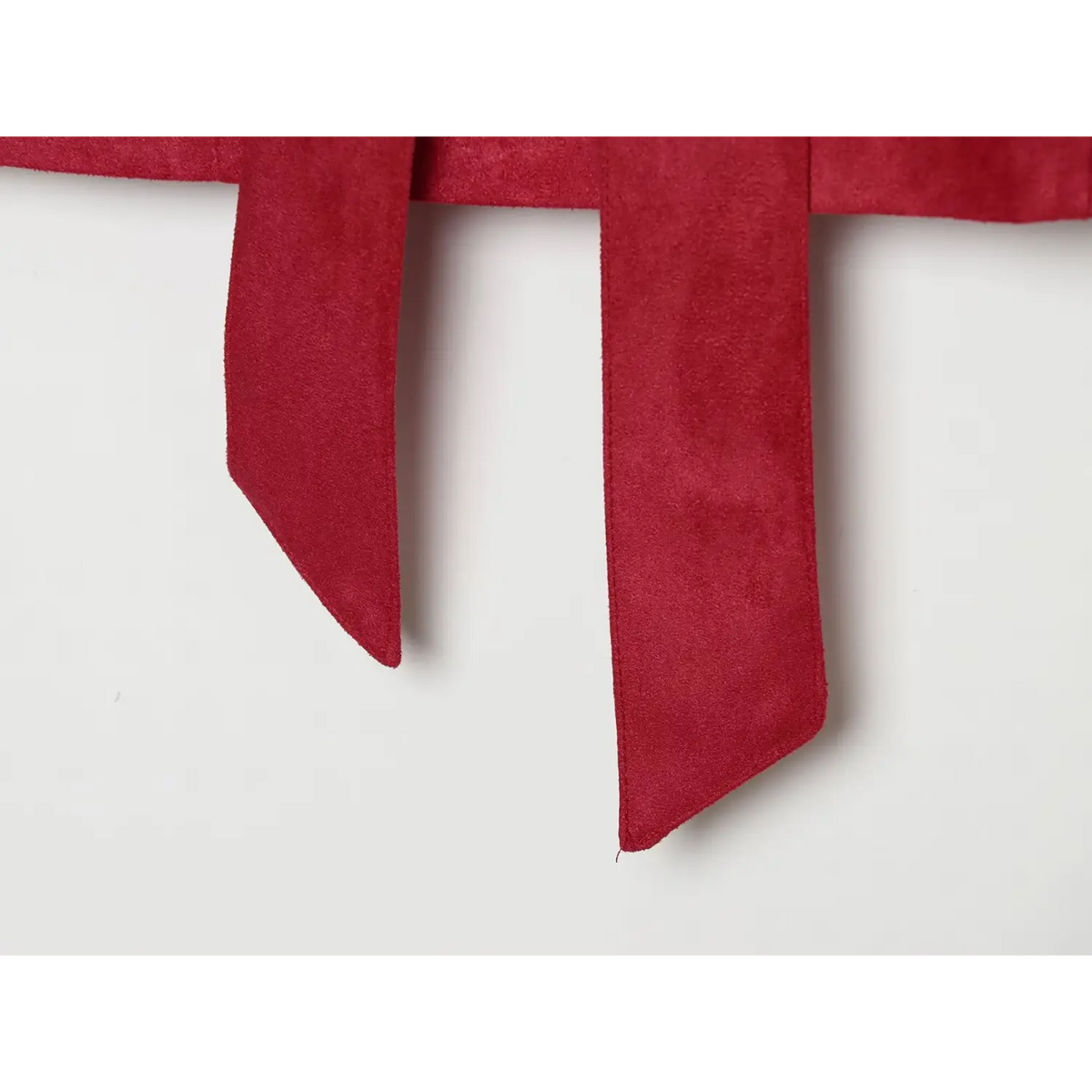 Close-up of belt tails with pointed ends