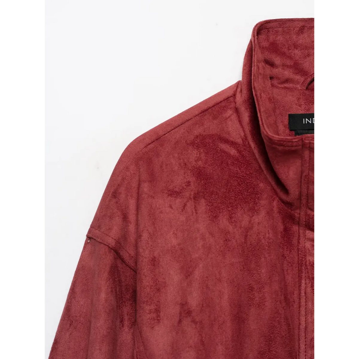Close-up of stand collar, shoulder seam and faux suede texture