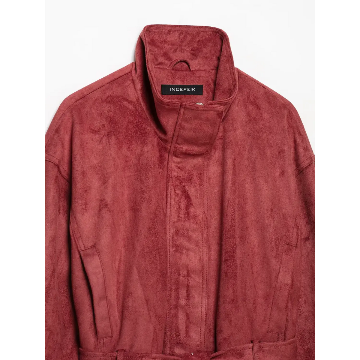 Close-up of stand collar, front zip and inner neck label
