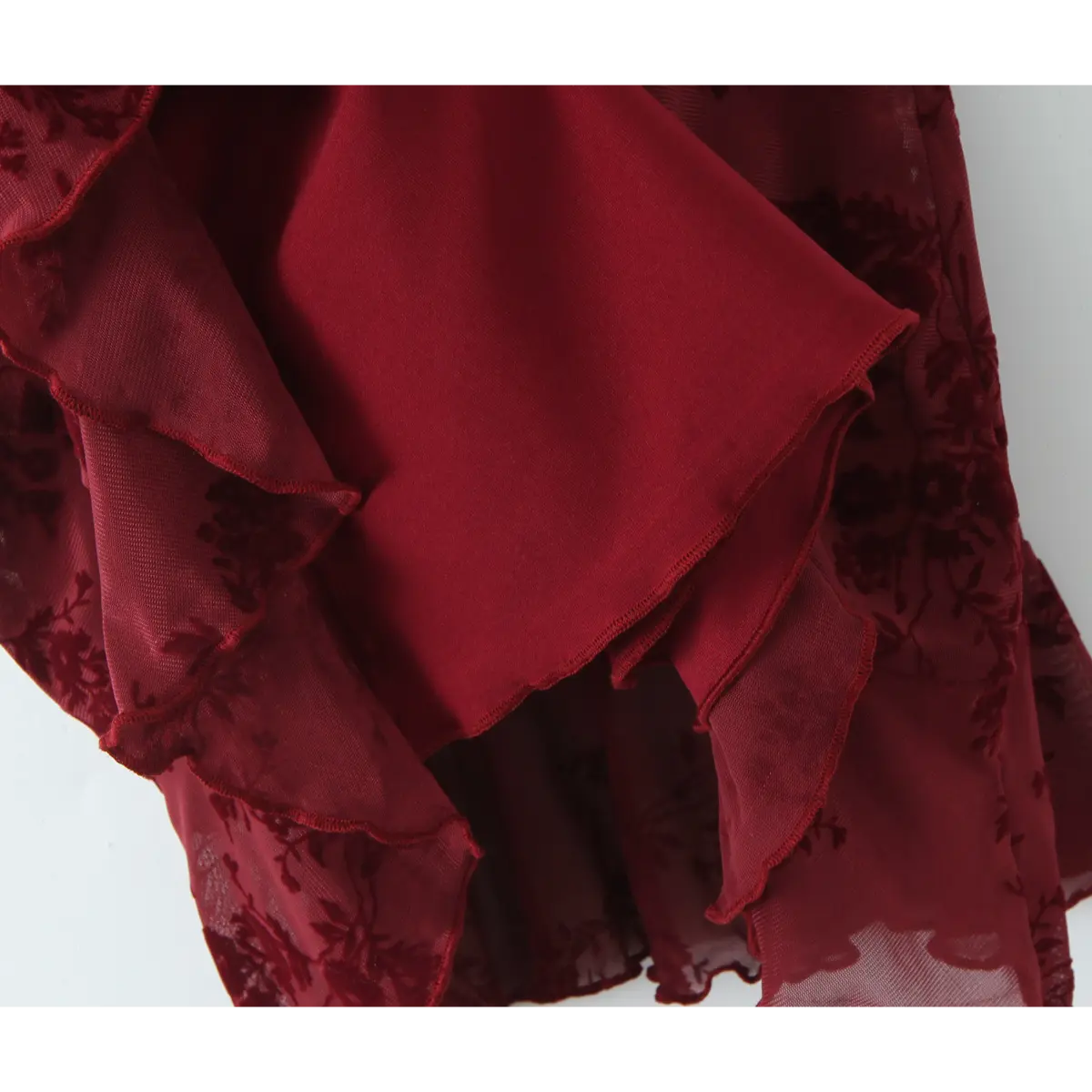 Close-up of the layered fabric and texture on the burgundy floral cami dress.
