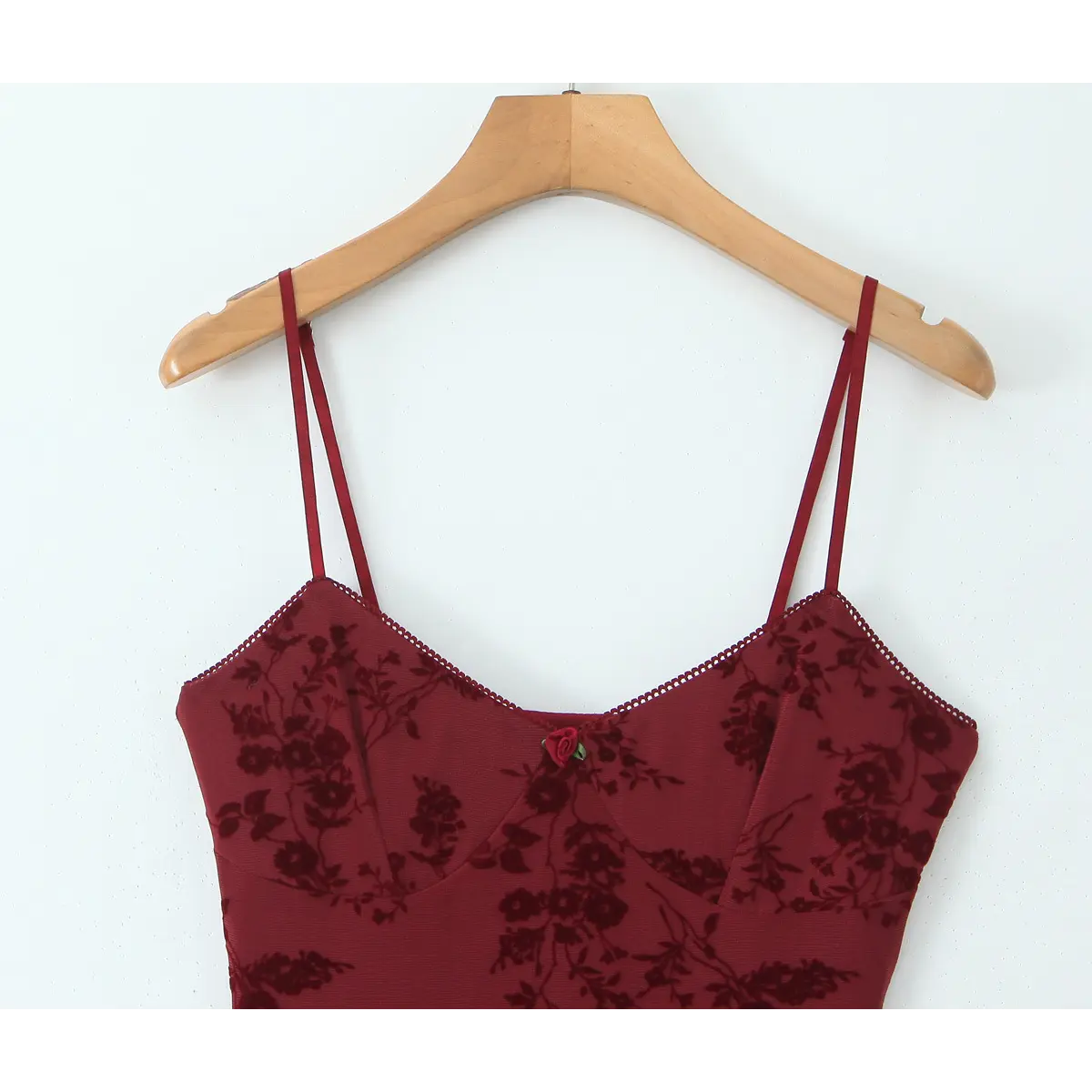 Close-up front view of the V-neckline and bust area on the burgundy floral cami dress.