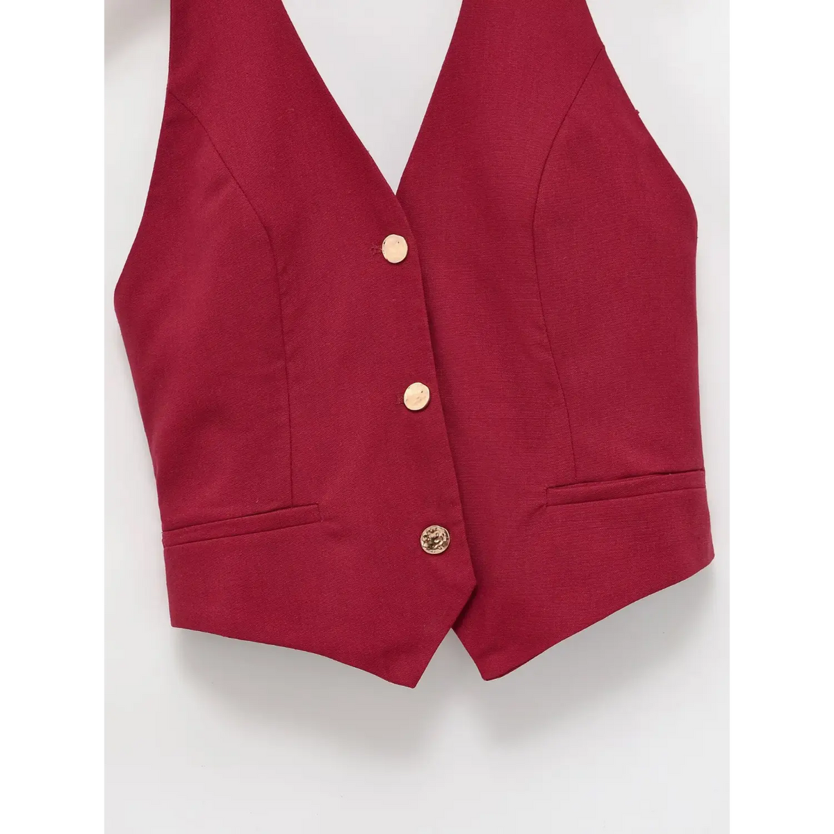 Close-up of gold buttons and fake flap pockets
