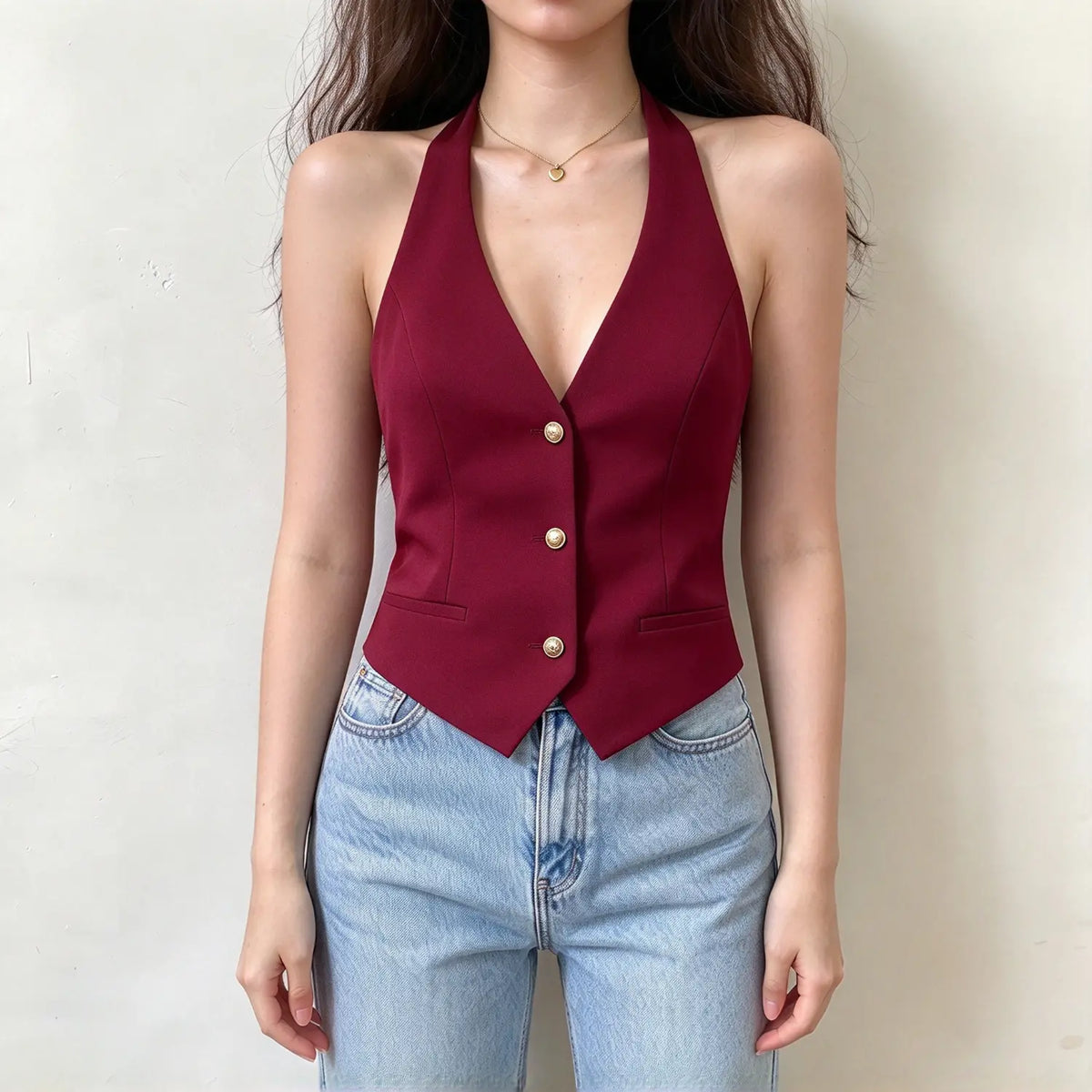 Model wearing burgundy halter button front vest, front view