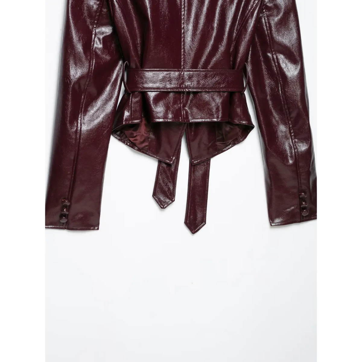 Close-up of back hem, belt ties and button cuffs on burgundy leather blazer