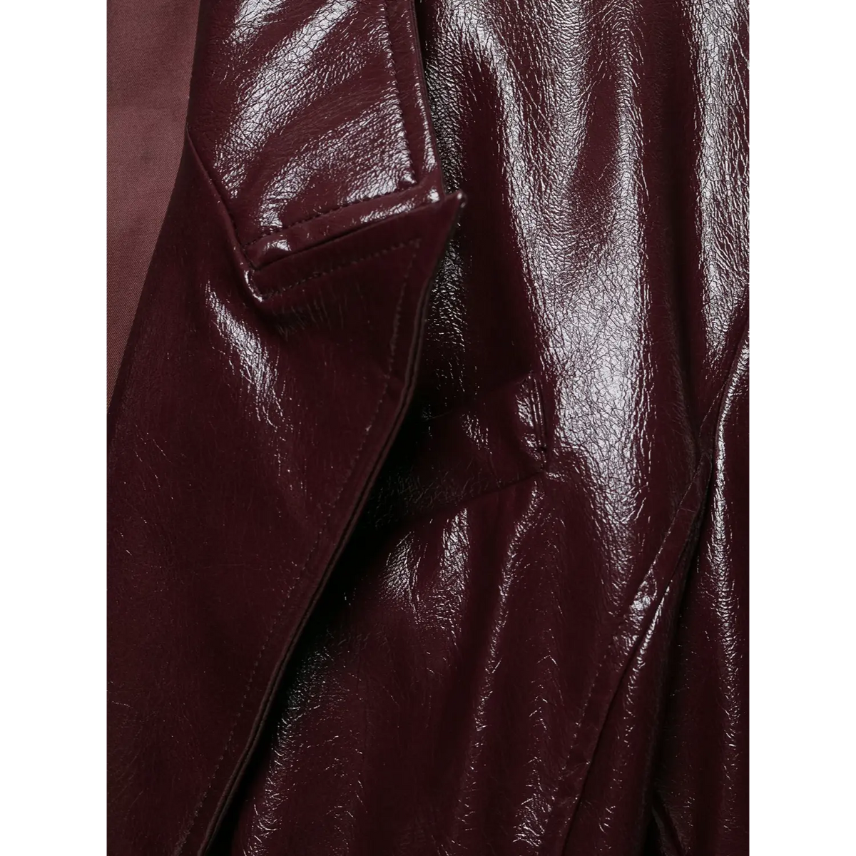 Close-up of notch lapel detail on burgundy crinkled leather look fabric