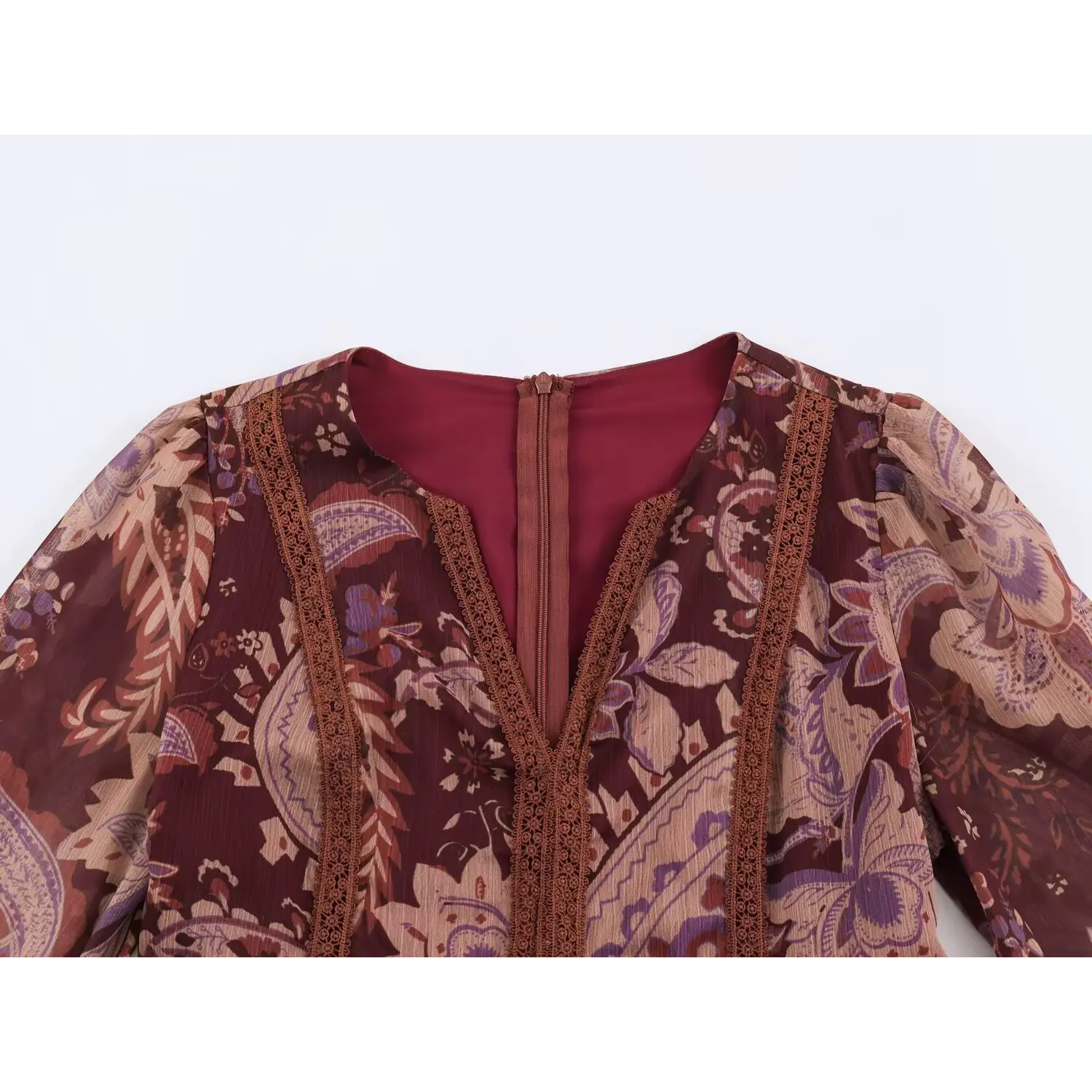Close-up of deep v-neck, delicate crochet lace trim and hidden back zipper on burgundy paisley maxi dress