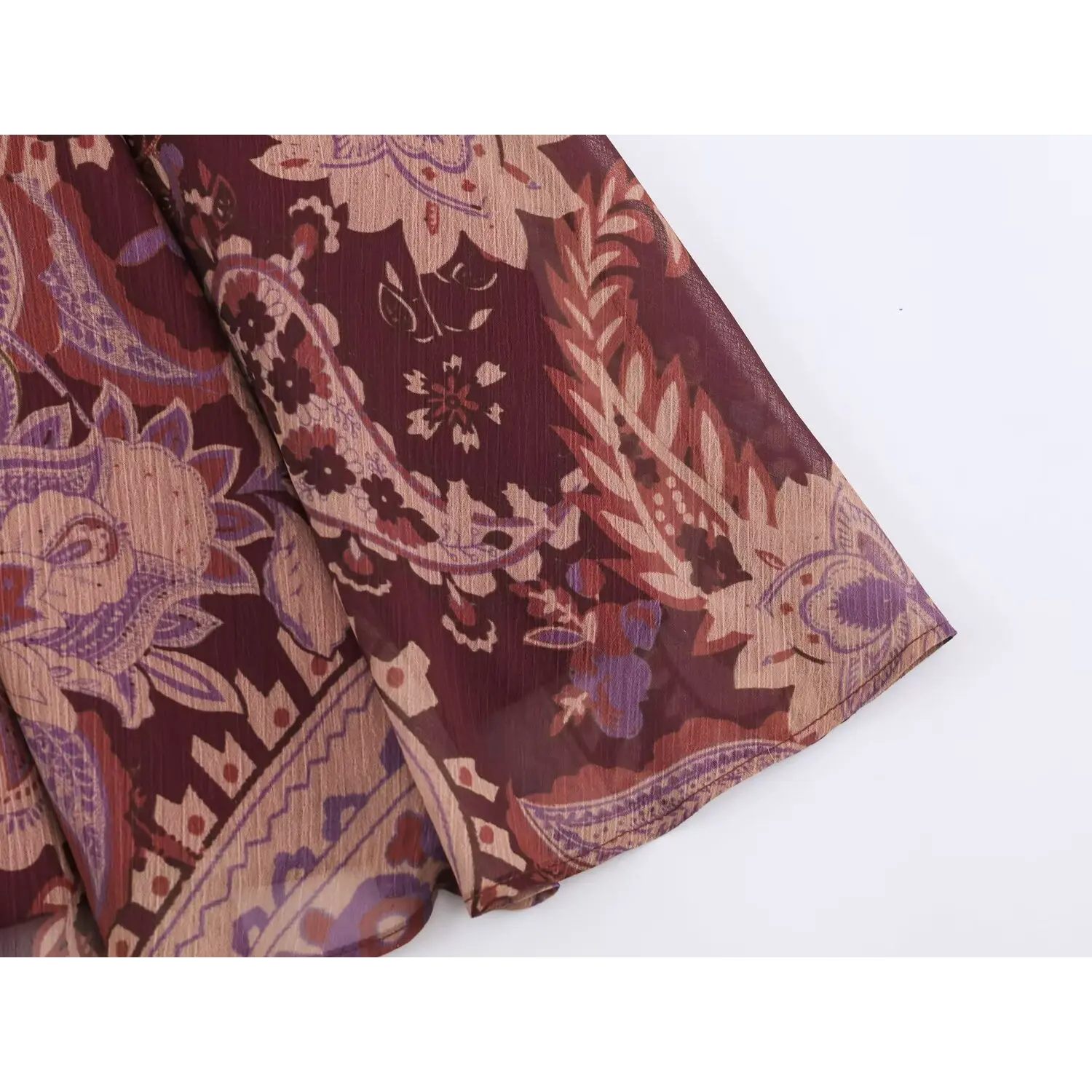Close‑up of burgundy paisley print crinkle chiffon skirt fabric