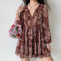 Model wearing burgundy paisley boho mini dress with balloon long sleeves