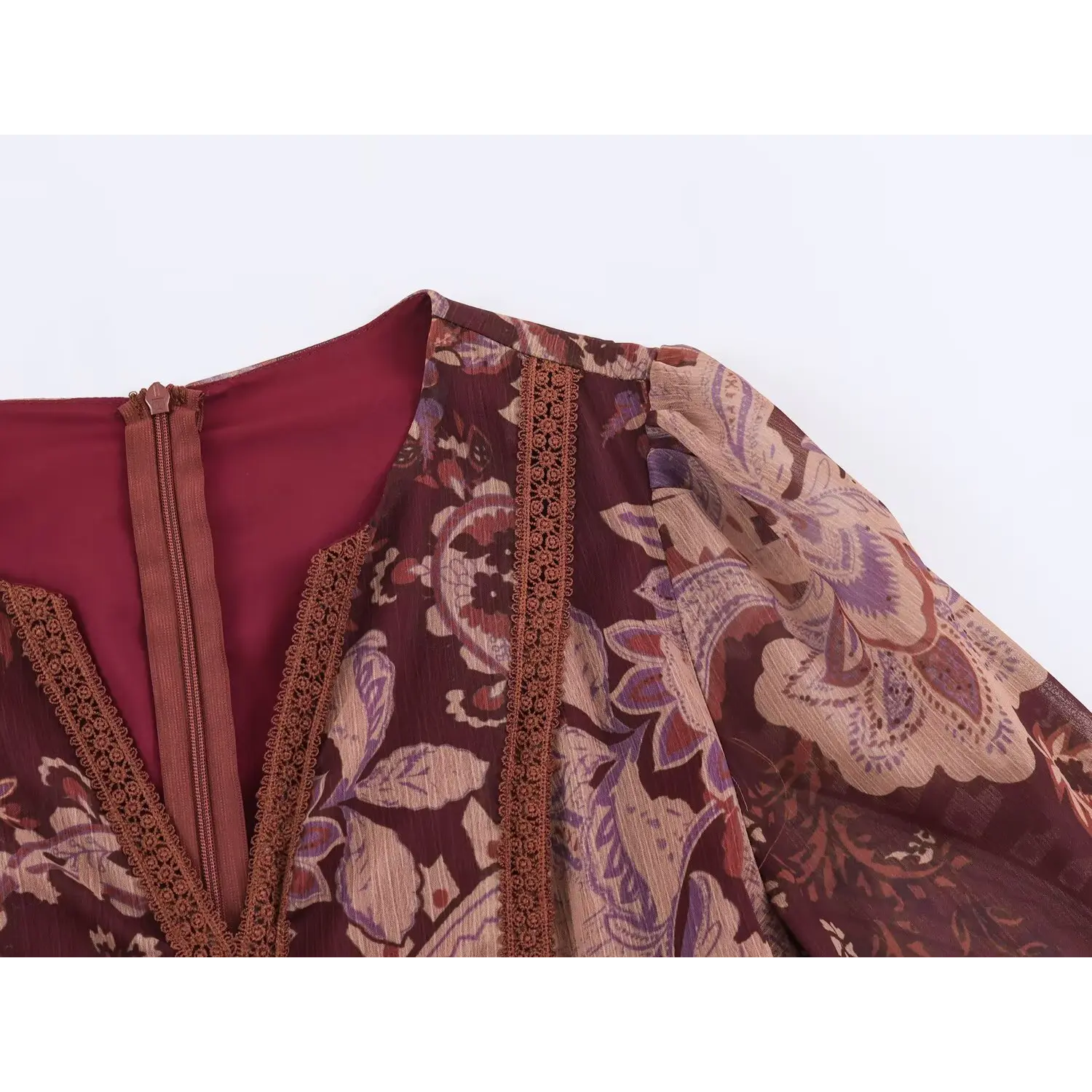 Macro close-up of rich burgundy paisley print on lightweight crinkle chiffon fabric