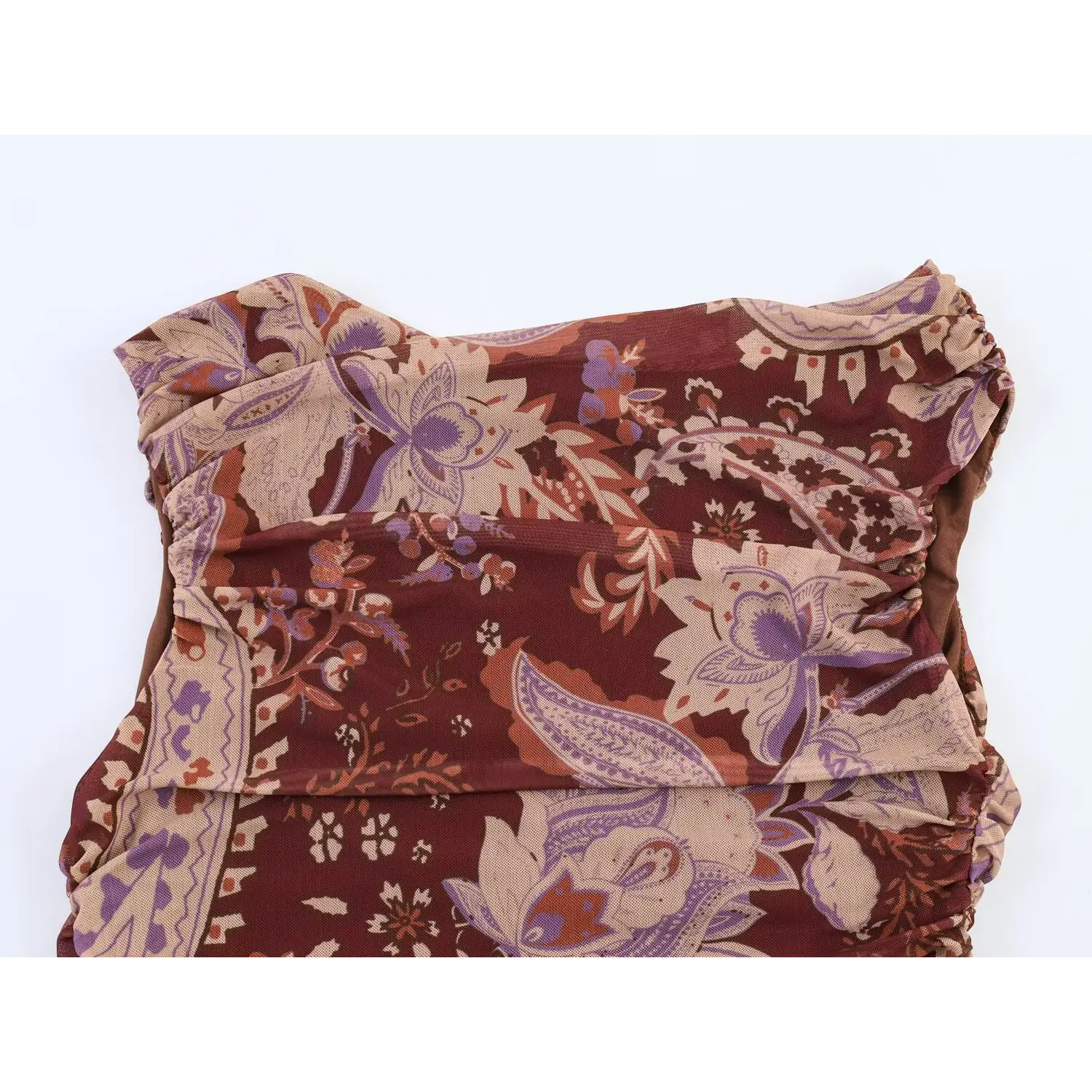 Top view of strapless bodice with side ruched construction on burgundy paisley mesh maxi dress