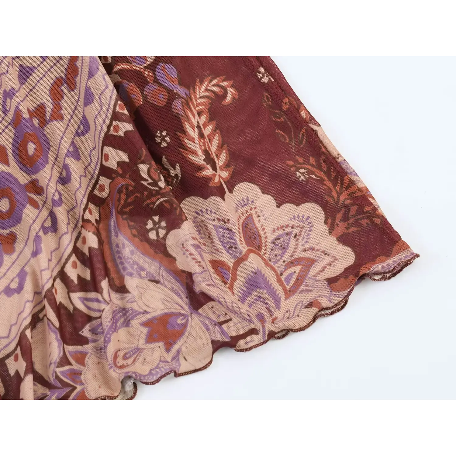 Close-up of skirt hem fabric on burgundy paisley mesh maxi dress, scalloped edge and vintage floral print