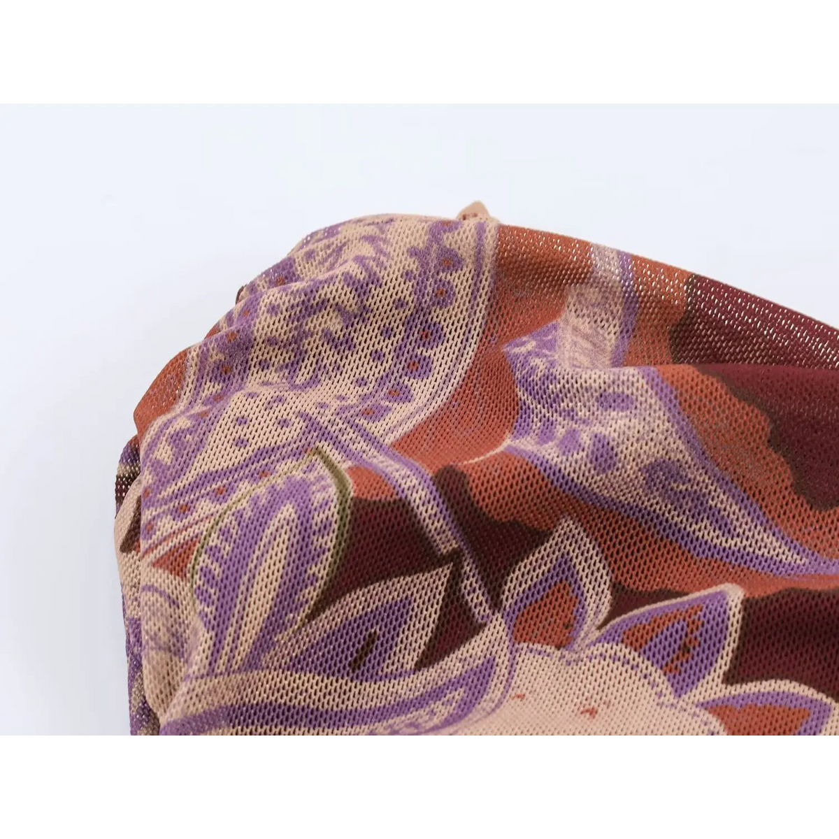 Close‑up texture of lightweight stretch mesh fabric in burgundy paisley pattern