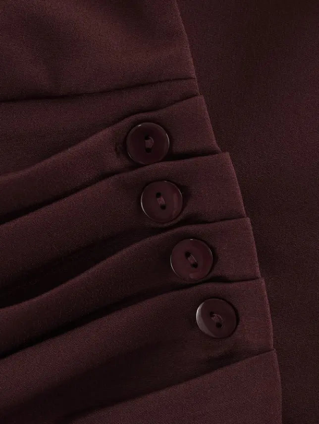 Macro close-up of four burgundy ruched side buttons