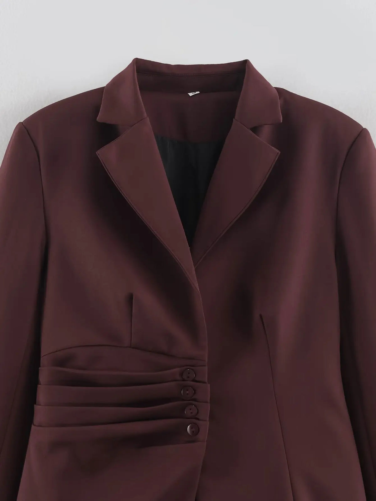 Close-up of notch lapel and ruched button side