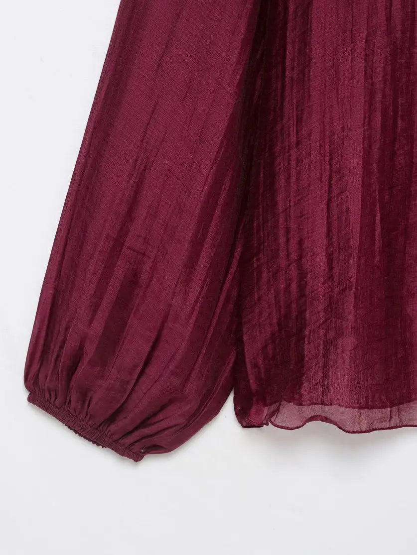 Close-up of elastic balloon cuff and sheer hem