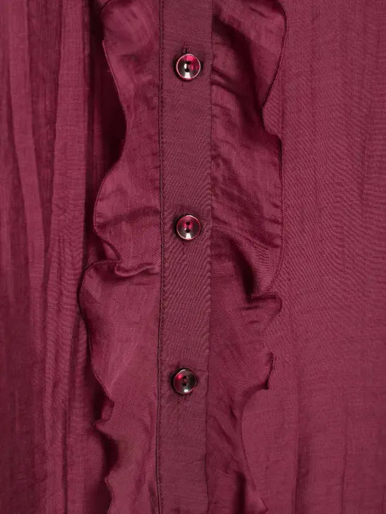 Macro close-up of ruffle trim and button stitching