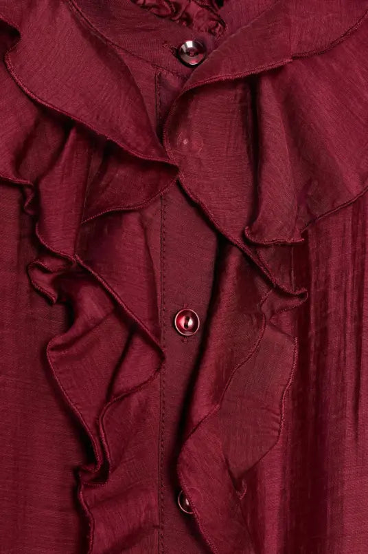 Macro close-up of ruffle collar and burgundy buttons