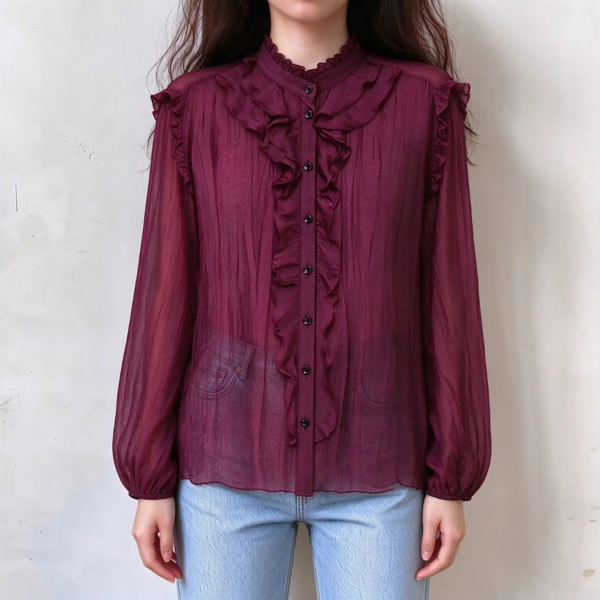 Model wearing burgundy ruffle stand collar balloon sleeve blouse with jeans, front view
