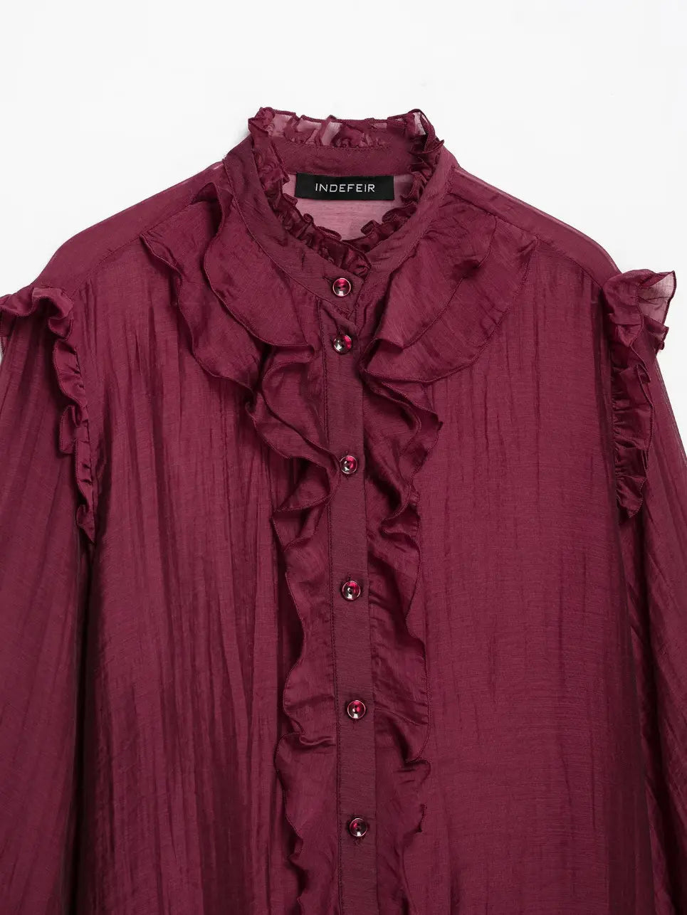 Close-up of ruffle stand collar and button placket