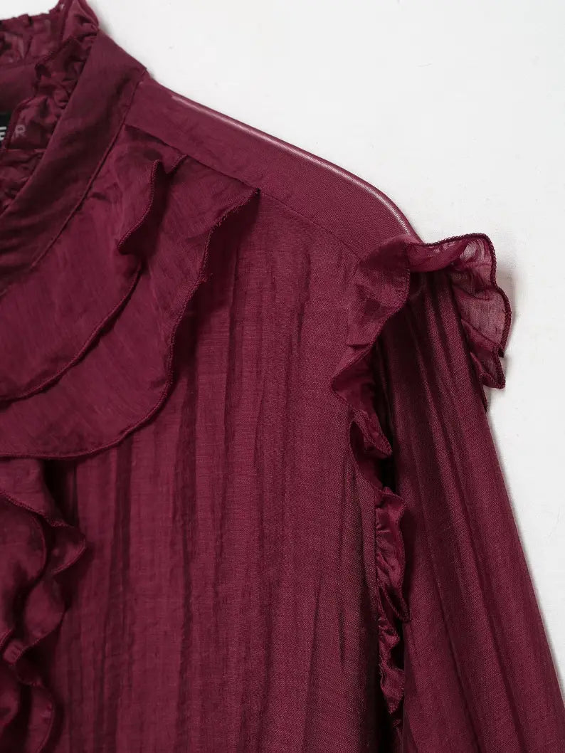 Close-up of shoulder ruffle and sheer sleeve